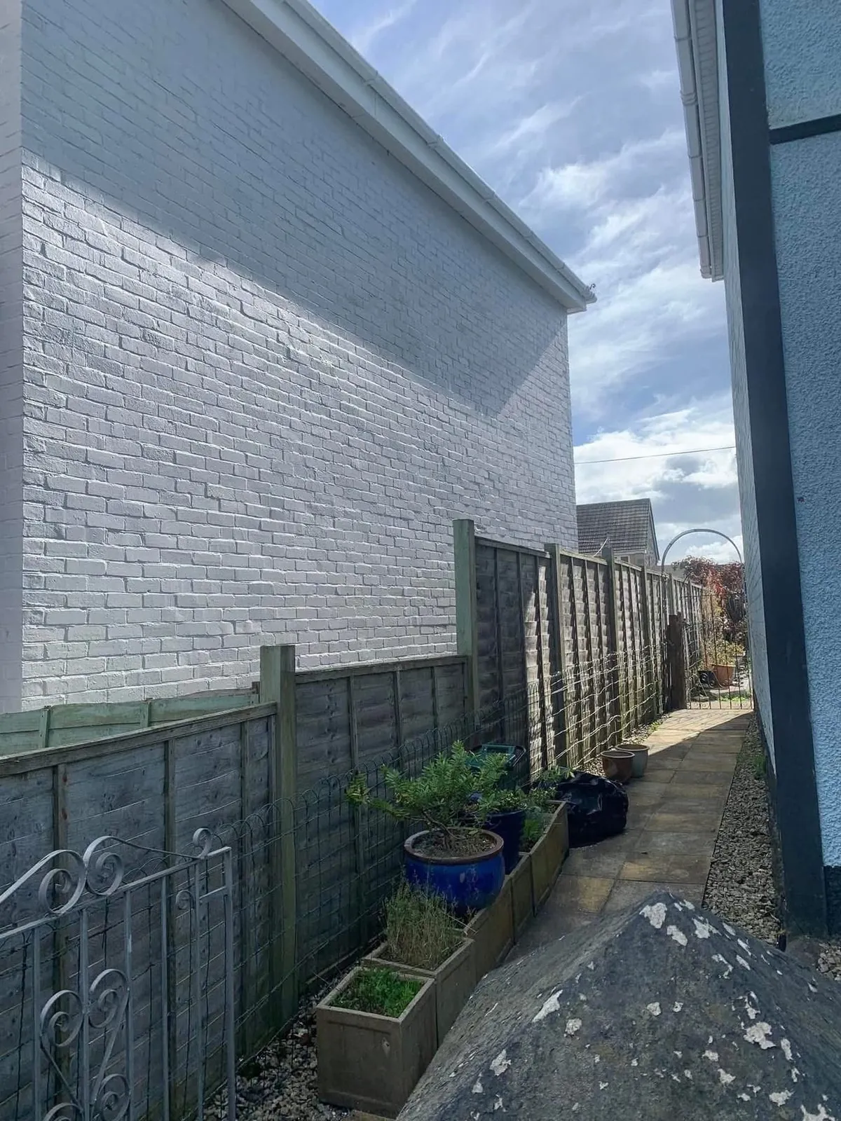Freshly painted brick wall after preparation and masonry paint in Mevagissey